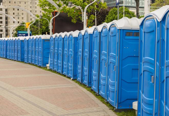 a line of brightly-colored portable restrooms, perfect for outdoor festivals and concerts in Bermuda Dunes